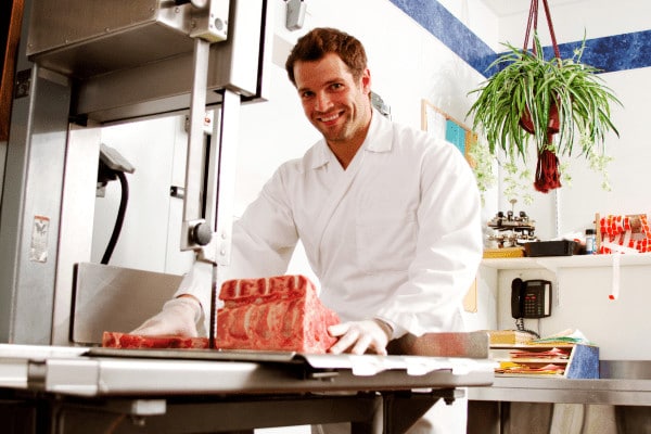 butcher cutting meat on band saw 600 x 400 1